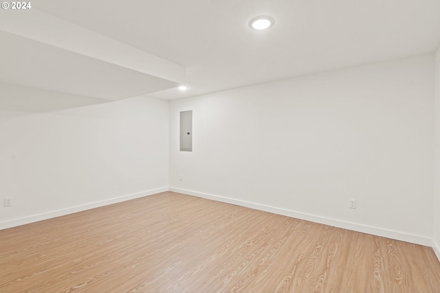 basement with light hardwood / wood-style flooring