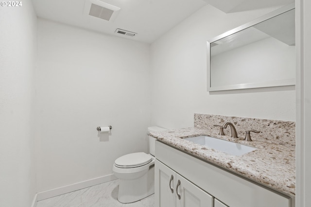 bathroom featuring toilet and vanity