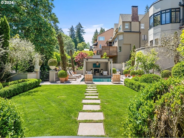 view of yard with a balcony, a patio, and an outdoor hangout area