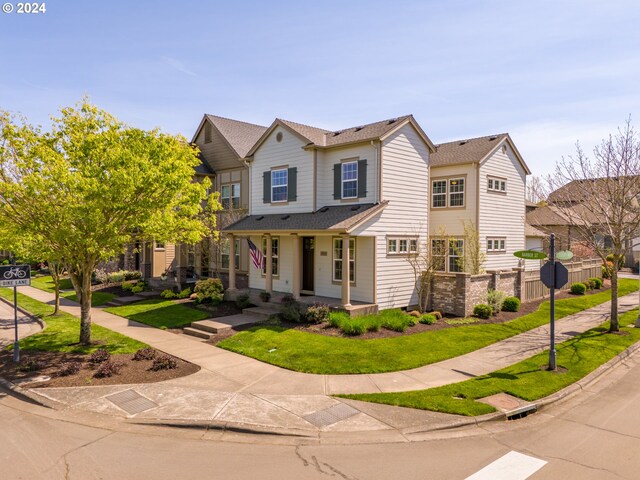 view of front of home featuring covered porch and a front yard