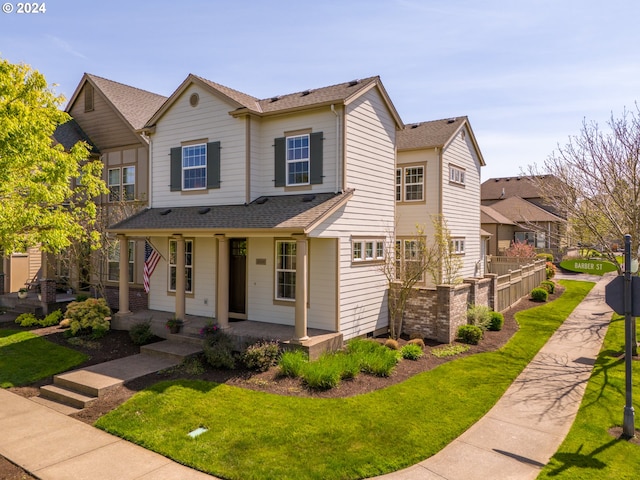 view of front of house featuring a front yard and covered porch