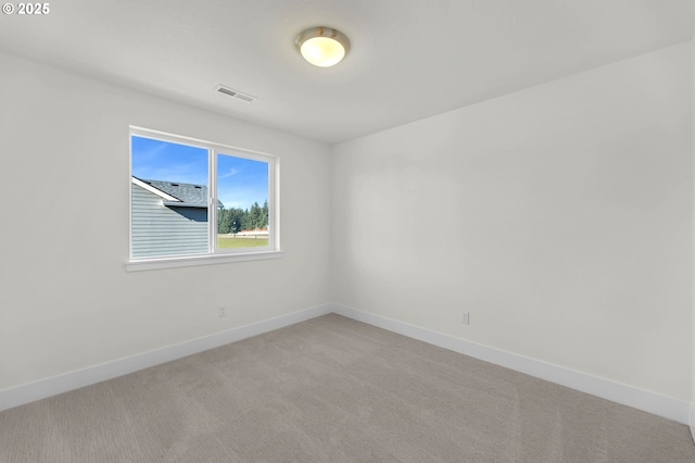 unfurnished room featuring light carpet