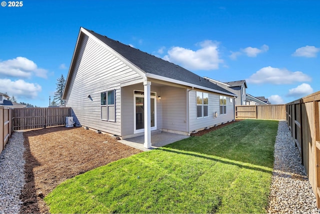 rear view of house featuring a lawn and a patio area