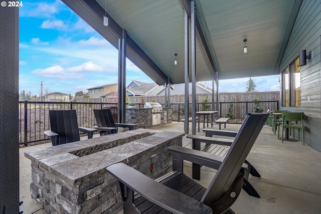 view of patio / terrace featuring an outdoor kitchen, exterior bar, and area for grilling