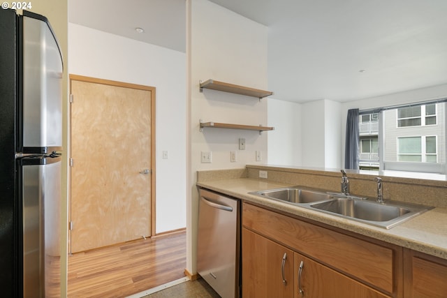 kitchen featuring hardwood / wood-style floors, sink, and stainless steel appliances