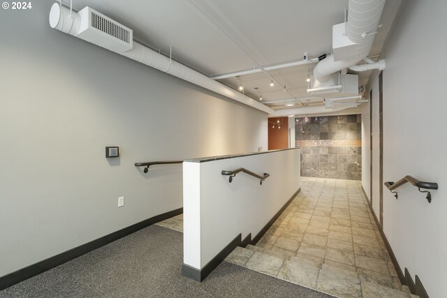 hallway featuring tile walls