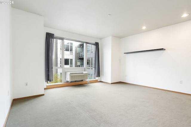 carpeted spare room with a wealth of natural light and cooling unit