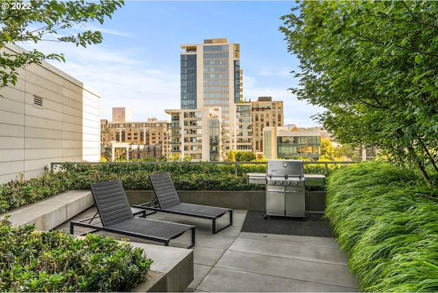 view of patio featuring a grill and a city view