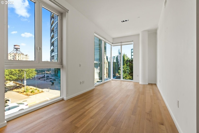 spare room with light hardwood / wood-style flooring