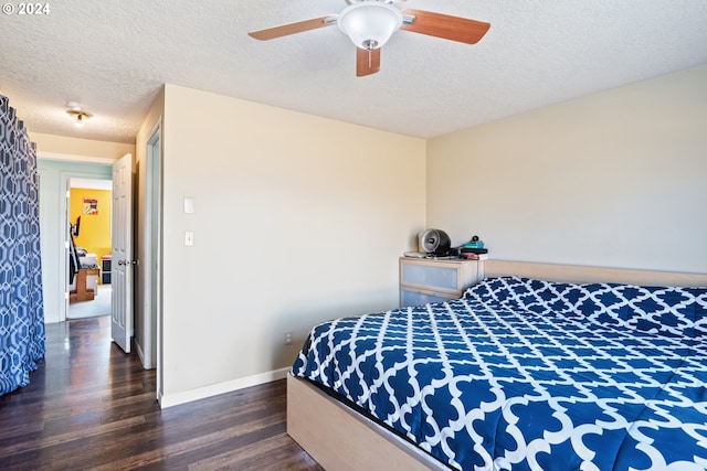 bedroom with a textured ceiling, ceiling fan, and dark wood-type flooring