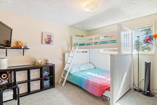 carpeted bedroom featuring a textured ceiling