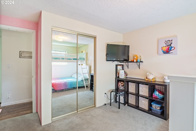 bedroom with carpet floors and a textured ceiling