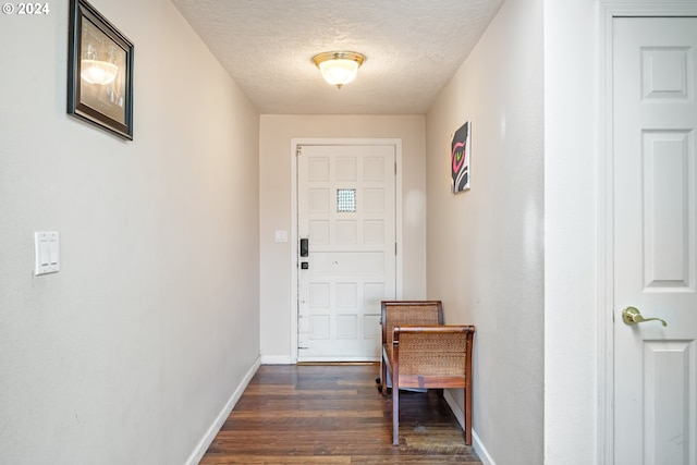 entryway with a textured ceiling and dark hardwood / wood-style flooring