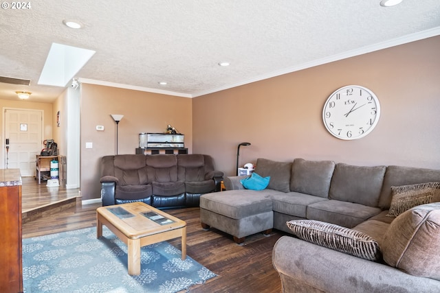 living room featuring a textured ceiling, dark hardwood / wood-style floors, crown molding, and a skylight