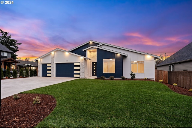 view of front of home featuring a yard and a garage