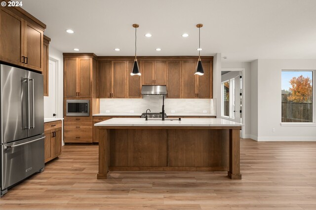 kitchen with backsplash, stainless steel appliances, and range hood