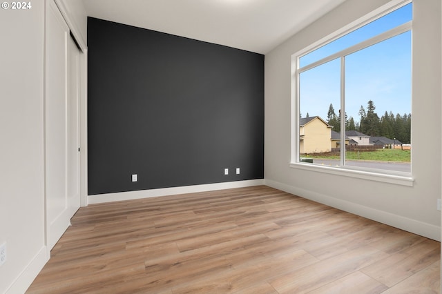 unfurnished room with light wood-type flooring