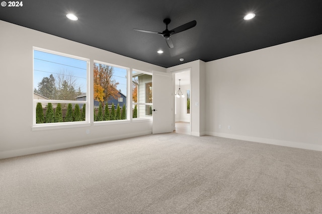 interior space featuring ceiling fan with notable chandelier