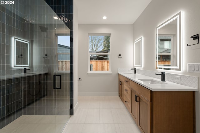 bathroom featuring tile patterned flooring, vanity, and a shower with shower door