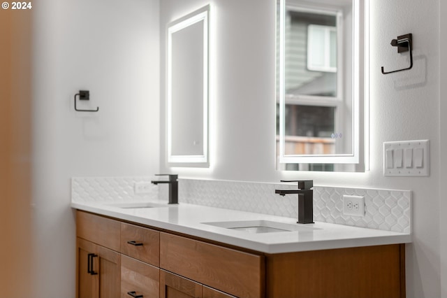 bathroom featuring vanity and tasteful backsplash