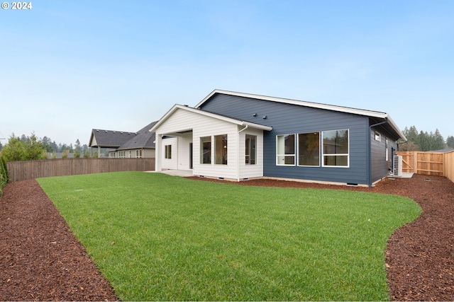 rear view of house with a yard