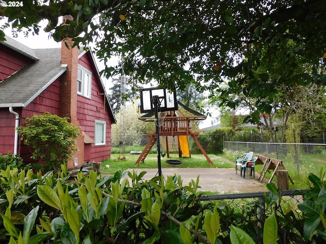 view of playground with a patio area