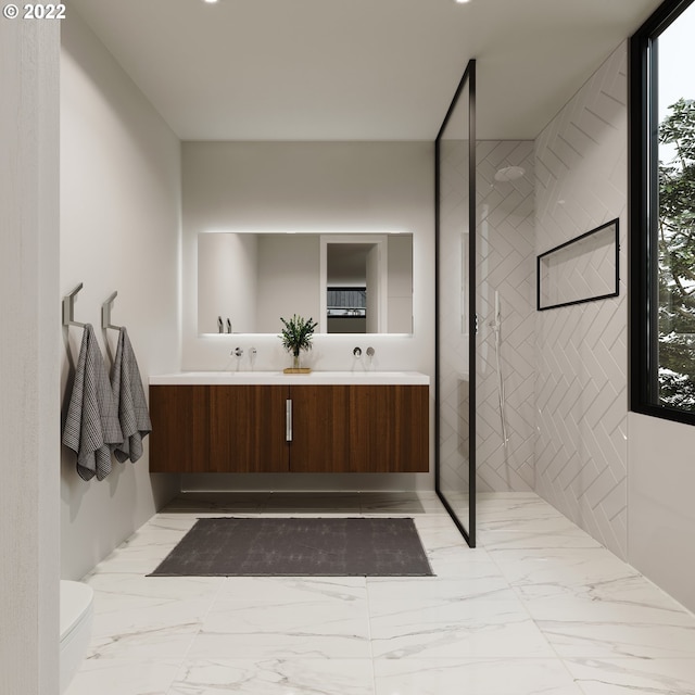 bathroom with a tile shower, vanity, and toilet