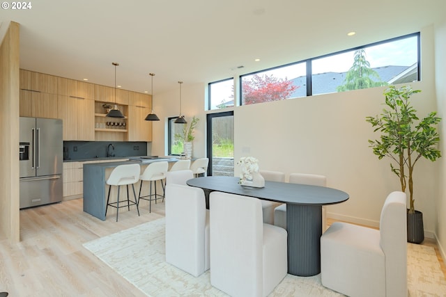 dining room featuring a mountain view, light wood-type flooring, and sink