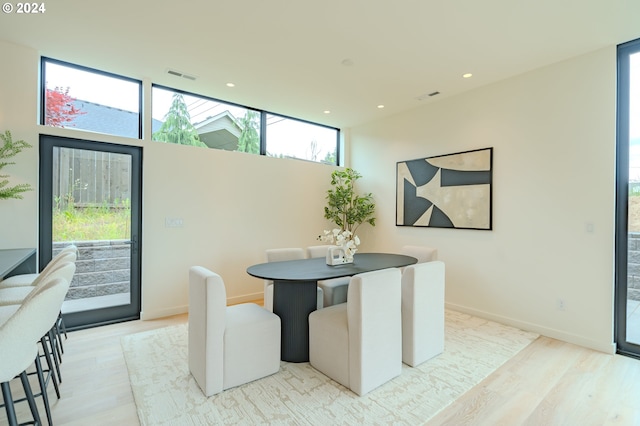 dining room featuring a wealth of natural light and light wood-type flooring