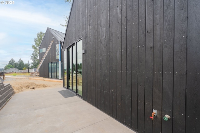 view of property exterior with a patio area