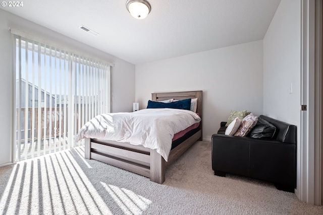 bedroom featuring access to outside and light colored carpet