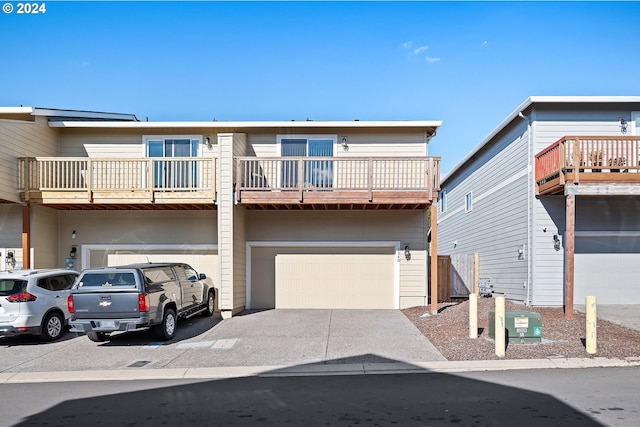 multi unit property with a balcony and a garage