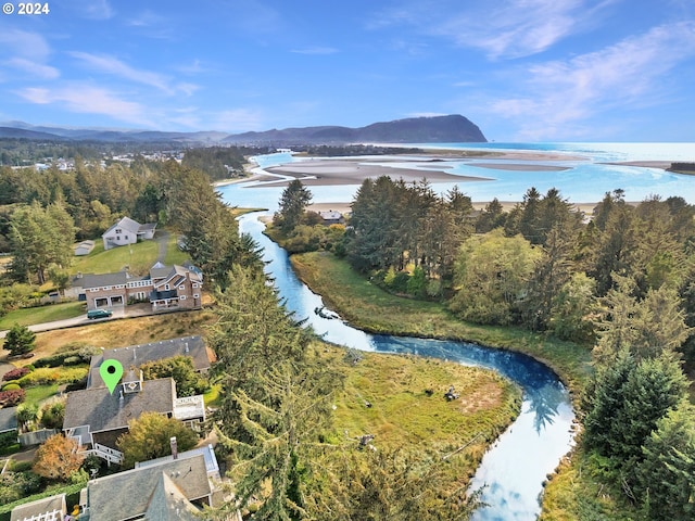 drone / aerial view featuring a water and mountain view