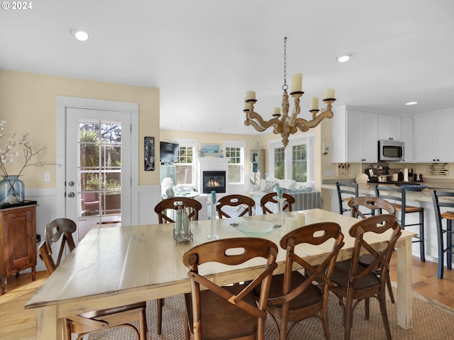 dining room with a chandelier and light hardwood / wood-style flooring