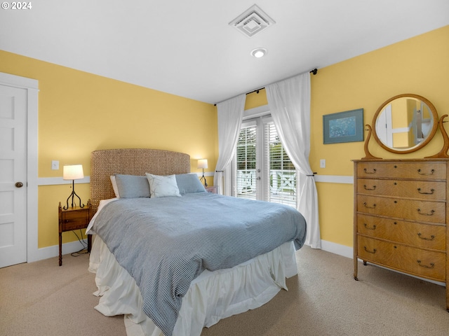 bedroom with light carpet and access to outside