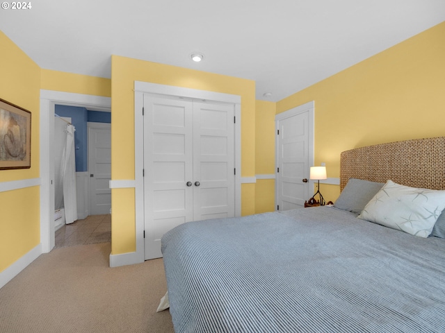 bedroom featuring a closet and light carpet