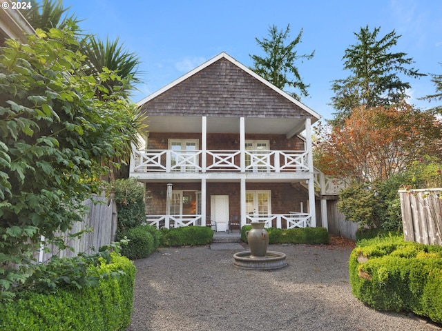 view of front facade featuring a balcony and a porch