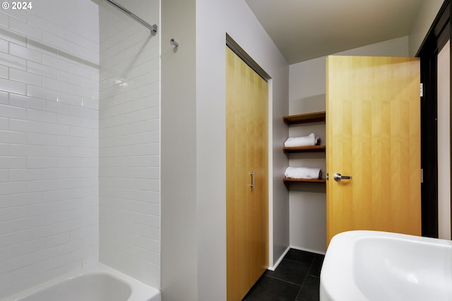 bathroom featuring tile patterned flooring and bathtub / shower combination