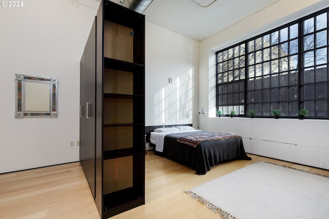 bedroom with hardwood / wood-style floors