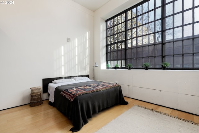 bedroom with hardwood / wood-style flooring