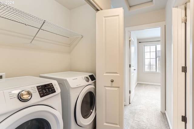 laundry area featuring light carpet and independent washer and dryer