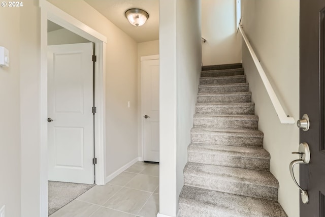 stairs featuring tile patterned floors