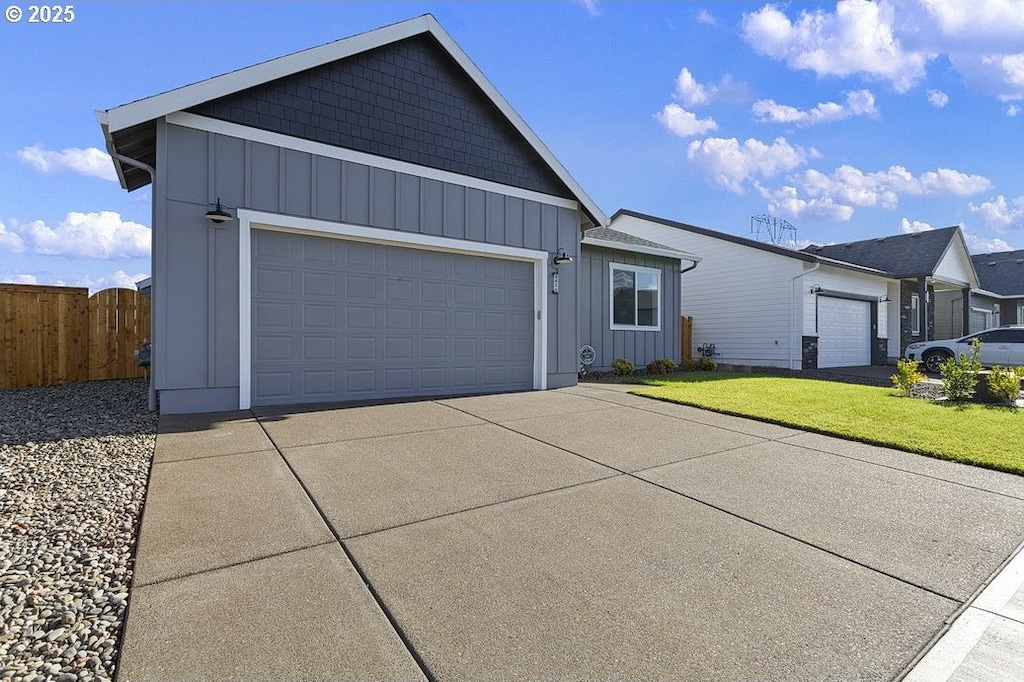 ranch-style house featuring a garage and a front lawn