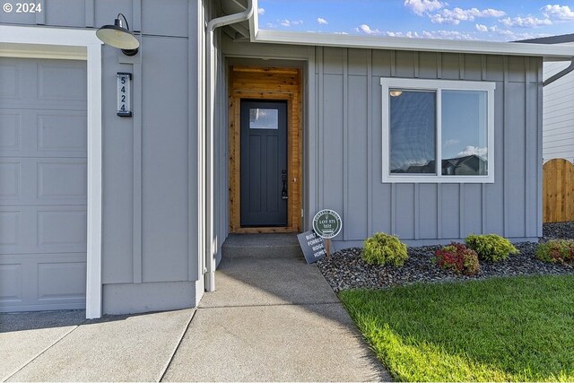 view of exterior entry with a garage