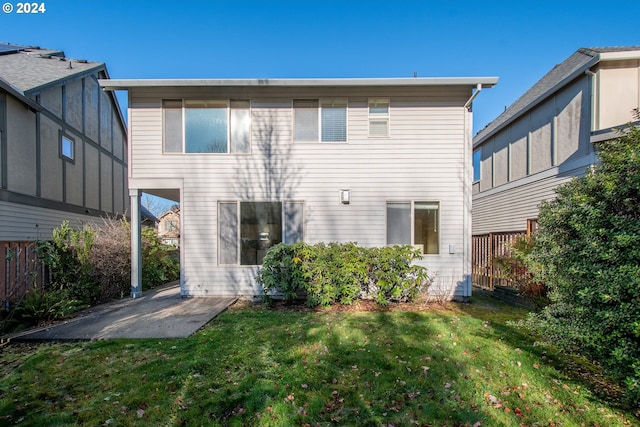 back of property featuring a lawn and a patio area