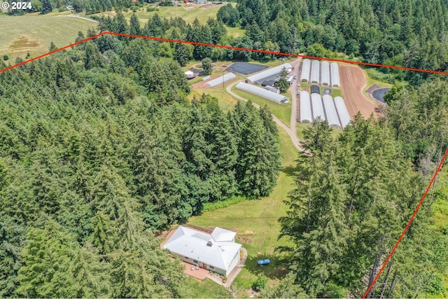 birds eye view of property with a forest view