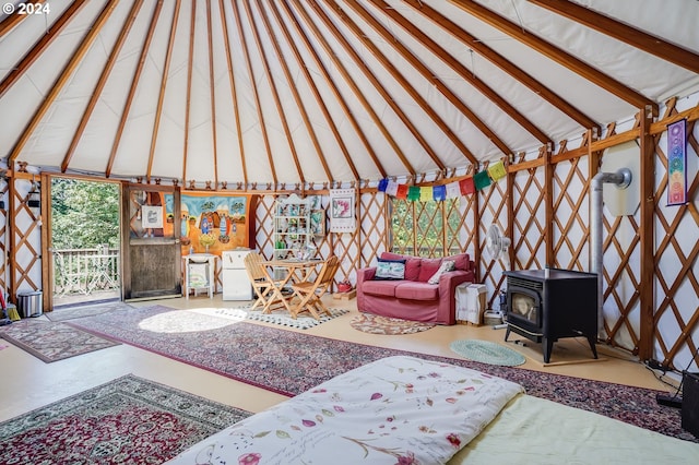 living room featuring vaulted ceiling with beams and a wood stove