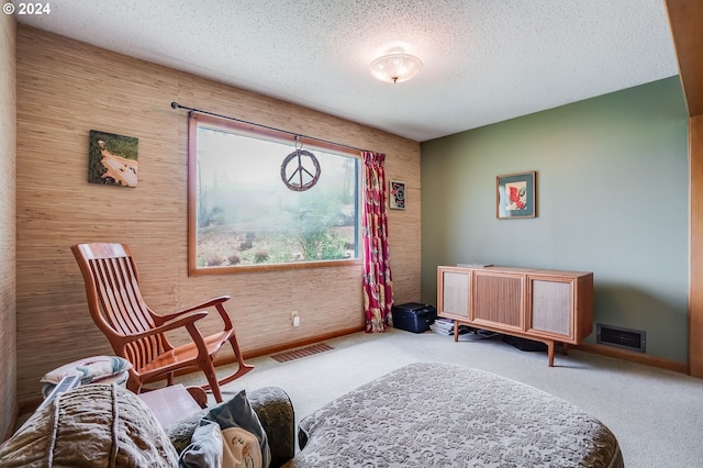 living area featuring a textured ceiling and carpet flooring