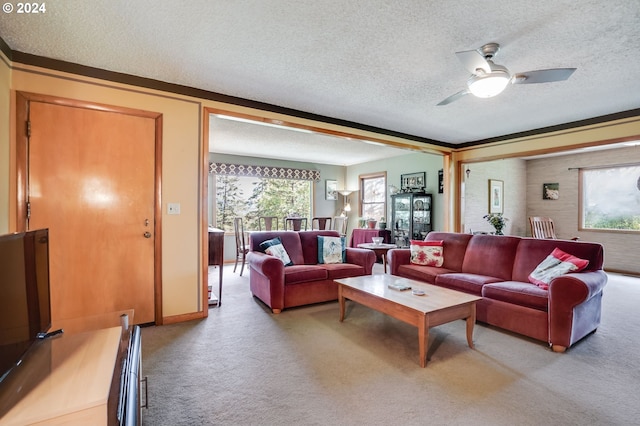 living room featuring ceiling fan, a textured ceiling, and light carpet