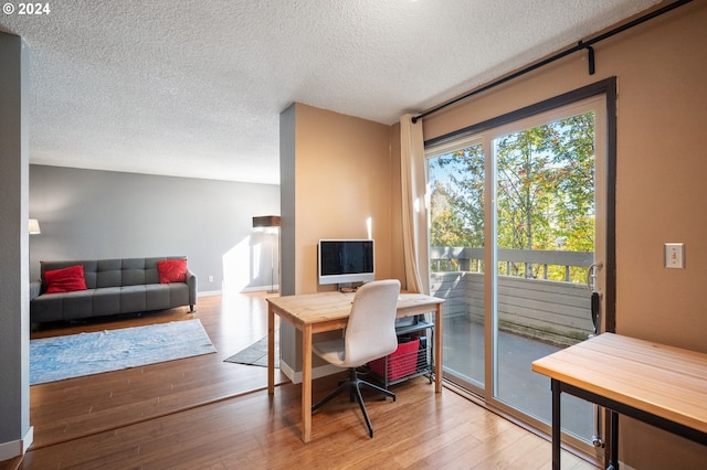 office area with a textured ceiling and wood-type flooring